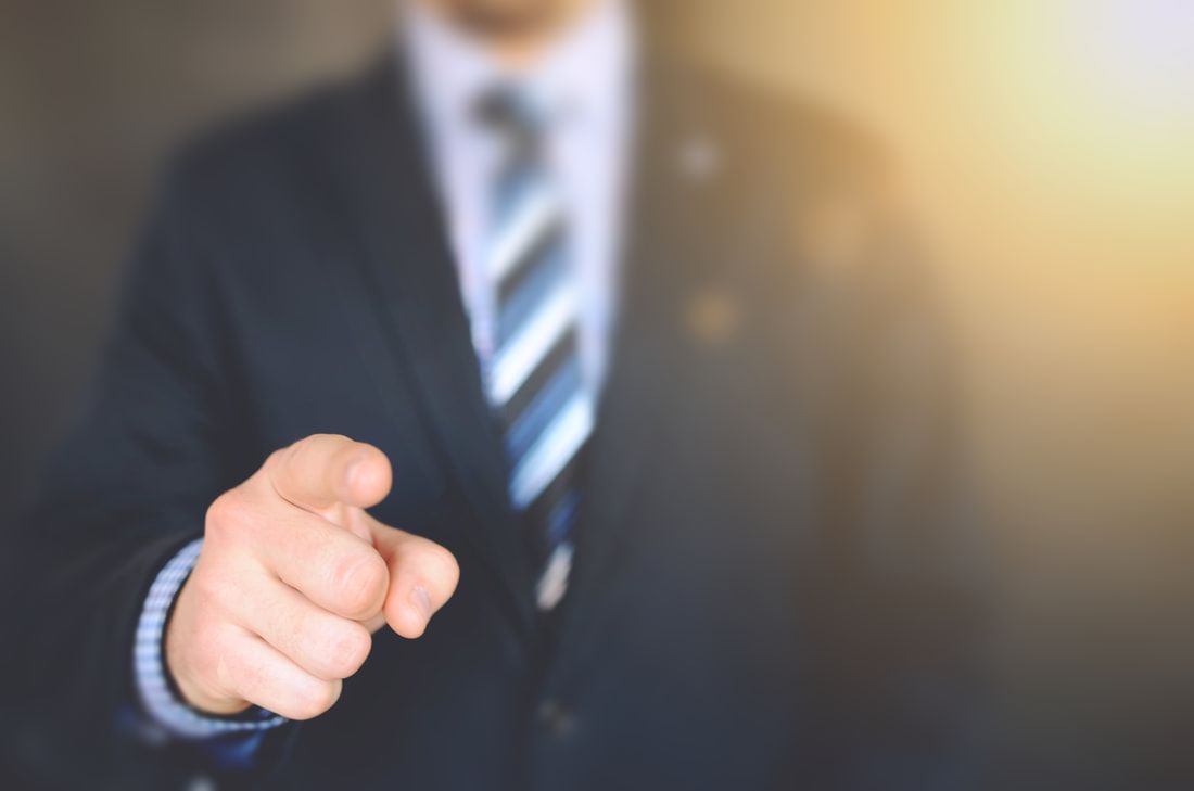 Man in a suit  pointing